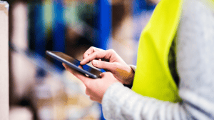 Individual with safety vest using tablet