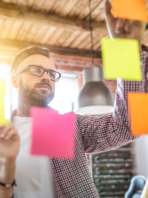 Man-Looking-at-Sticky-Notes
