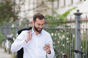 Man Using Mobile Phone While Walking on the Street