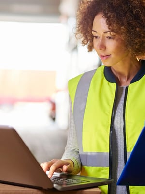 Woman-Using-Laptop-With-Safety-Vest